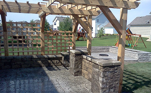 Stamped Patio featuring Seating Wall, Pillars, Pergola & Fire Pit