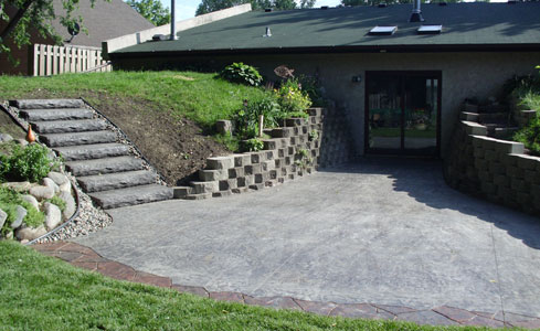 Stamped Concrete Patio with Steps & Brick Wall
