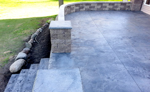 Stamped Concrete Patio with Steps, Brick Wall, and Pillars